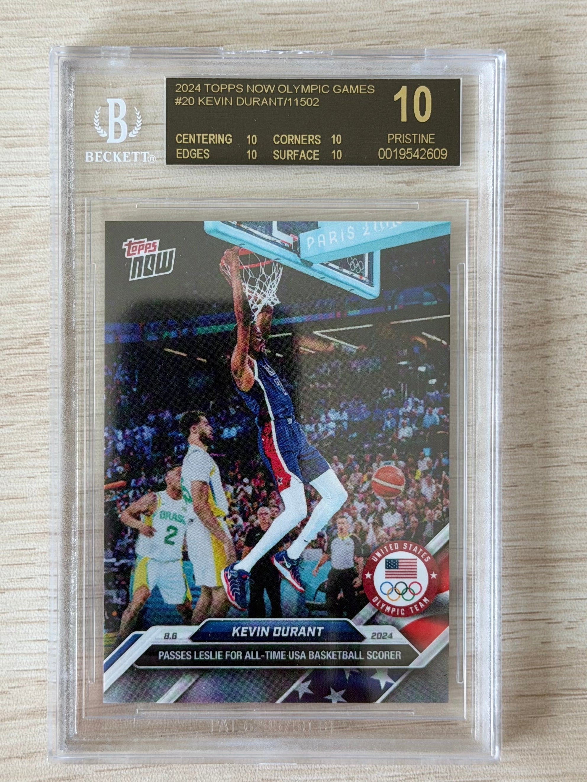 Basketball trading card of Kevin Durant in a protective case on a wooden surface